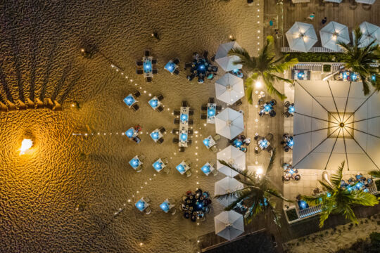 Drone view of a luxurious beach BBQ at night on Providenciales.