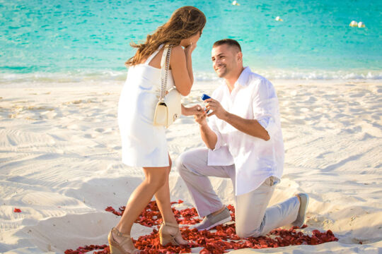 Man proposing to a woman on the beach in Turks and Caicos.