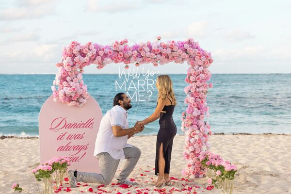 Couple getting engaged on Grace Bay Beach.