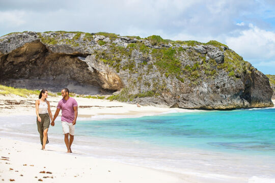 Couple walking on the beach at Mudjin Harbour.