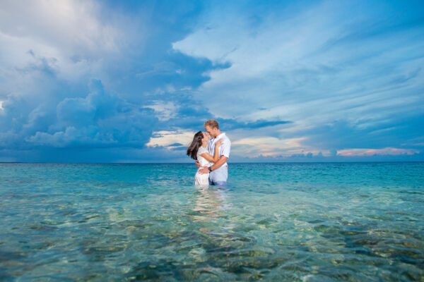 Couple in the shallows of the ocean in Turks and Caicos.