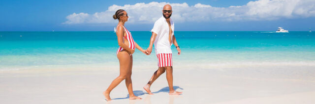 Couple doing a maternity shoot on Grace Bay Beach in Turks and Caicos. 