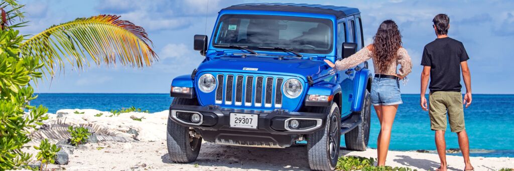 Couple with Jeep Wrangler near the beach