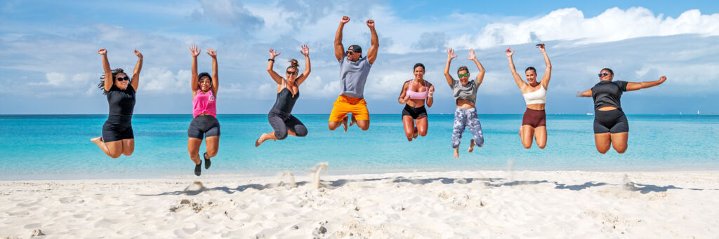 Group of people jumping on the beach in Turks and Caicos.