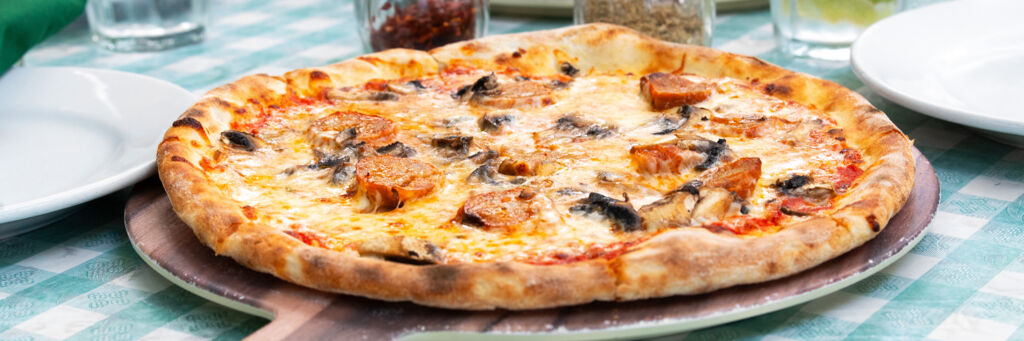 Thin-crust pizza with sausage.