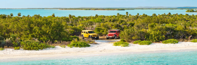 Rental Jeep Wranglers at a Providenciales beach.