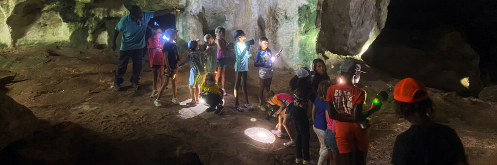 Kids exploring a cave in the Turks and Caicos