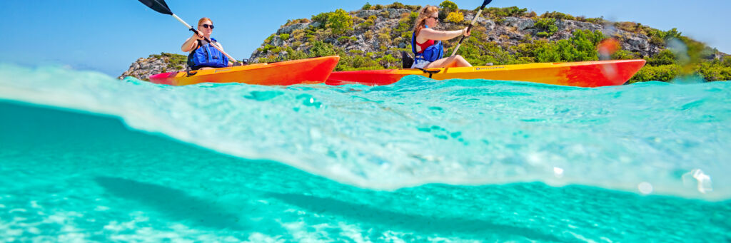 Overunder view of kayakers at Plandon Cay Cut