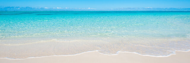 The calm and clear ocean water at Pumpkin Bluff Beach on North Caicos