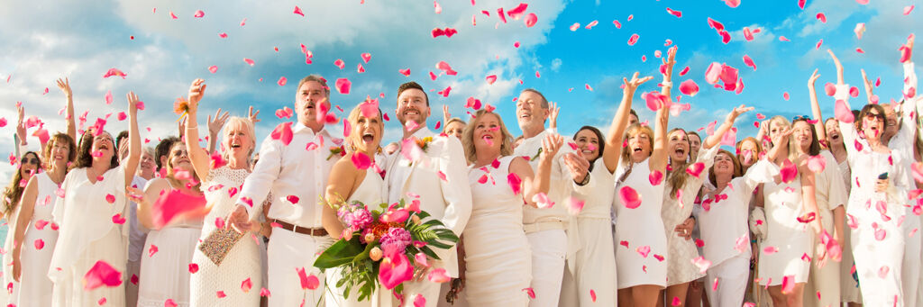 Wedding party tossing pink petals at a Grace Bay Beach wedding, Turks and Caicos.