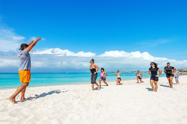 Group of women exercising on the beach in Grace Bay. 