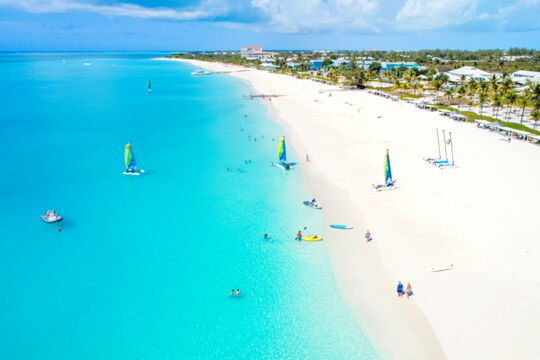 People enjoying water sports at Grace Bay Beach near the Club Med resort