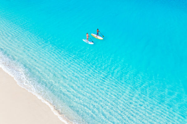 Overhead view of two people on paddle boards at Grace Bay Beach