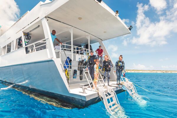 Divers on a liveaboard preparing for a dive on West Caicos. 