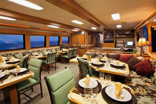 Dining room aboard the Turks and Caicos Aggressor II liveaboard at dusk.