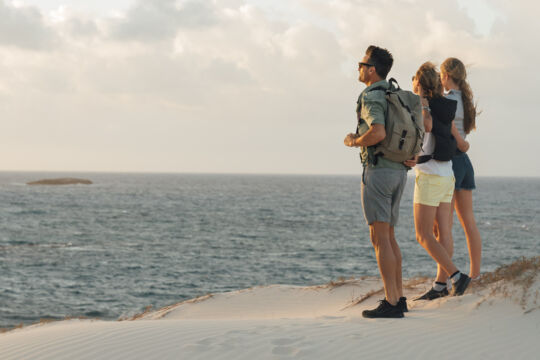 Hikers on a beach at Ambergris Cay