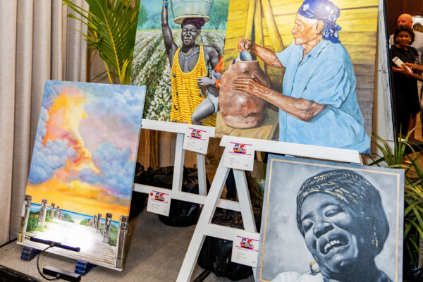 Fine art prints featuring people and landscapes at an art auction in Turks and Caicos. 