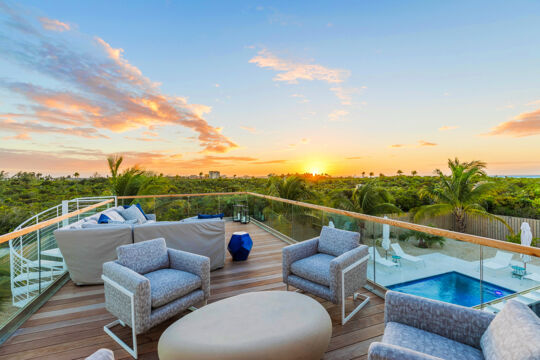 Private furnished deck at a luxury villa with great views of the sunset in Turks and Caicos. 