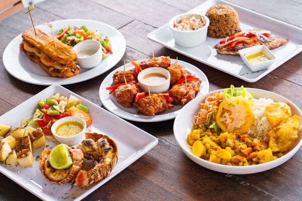 Plates of local Turks and Caicos cuisine at a Caribbean restaurant.