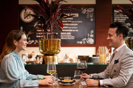 Couple enjoying wine and an appetizer at a restaurant