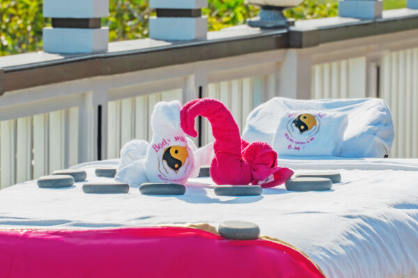 Hot stones and towel art on a massage table at a Turks and Caicos villa. 