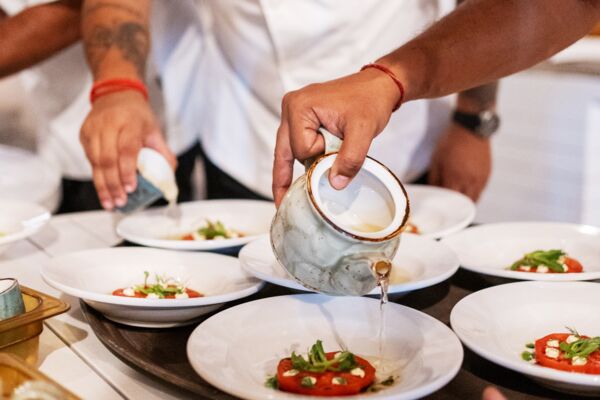 Chef preparing caprese salad.