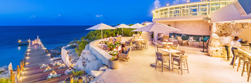 Modern coastal bar overlooking the ocean at dusk on Providenciales. 