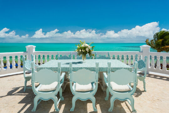 Table and chairs on a terrace near the ocean