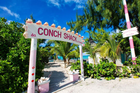 Entrance to Da Conch Shack with a colorful sign decorated with conch shells