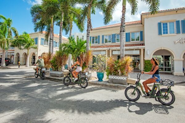 E-biking past shops and palm trees in Turks and Caicos.