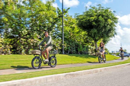 Electric bikes riding on a sidewalk in Turks and Caicos.