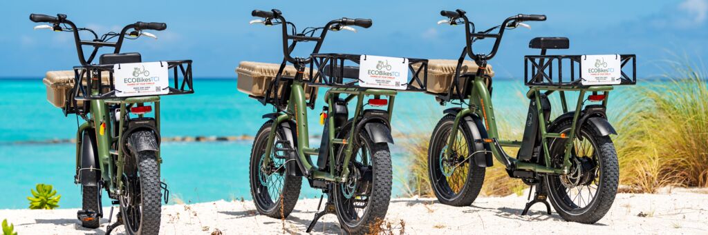 Electric bikes parked at a beach in Turks and Caicos.