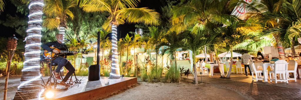 Musician performing at a seafood restaurant at night in Turks and Caicos.