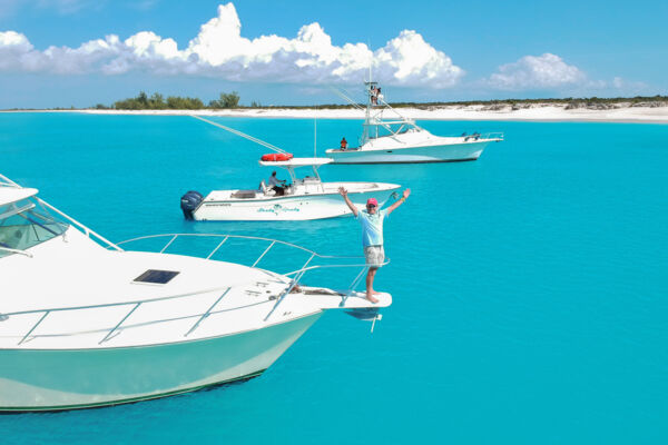 Man standing on the bow of a boat in Turks and Caicos.