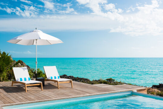 Loungers near the pool and ocean