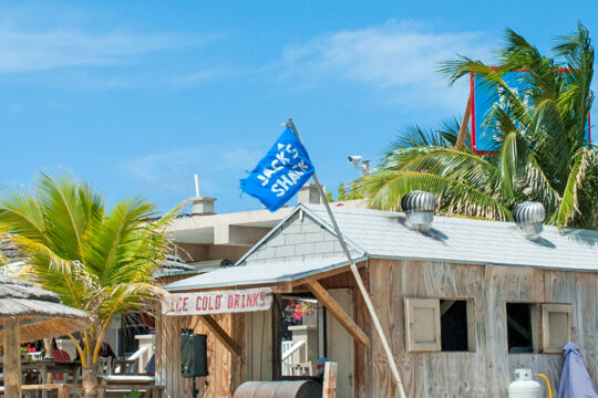 The wooden beach bar and palm trees at Jack's Shack Grand Turk