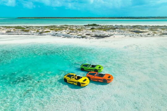 Orange, yellow, and green jet car in the water off Half Moon Bay, Turks and Caicos Islands.