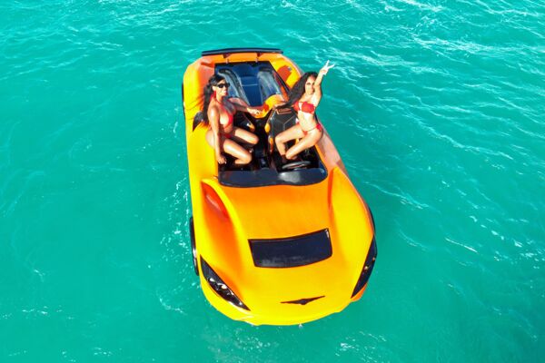 Women riding an orange jet car in the Turks and Caicos.