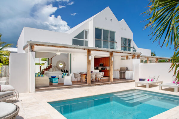 A luxury villa with a spacious pool and covered deck in Providenciales.