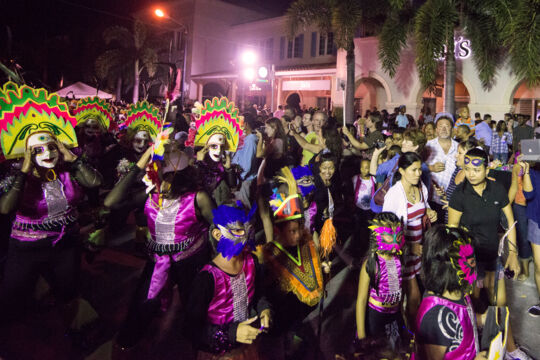 Junkanoo masqueraders parading down the street at night in Turks and Caicos.