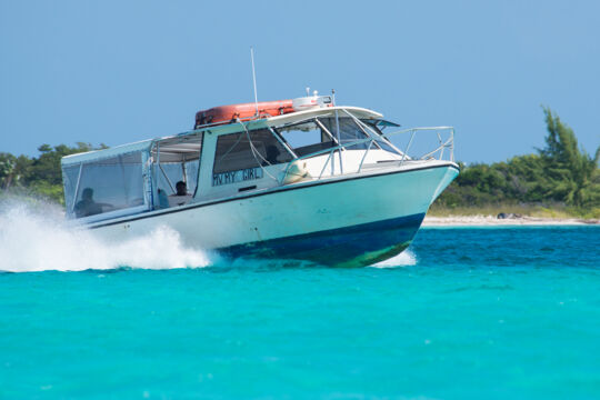 Moving passenger ferryboat in turquoise water