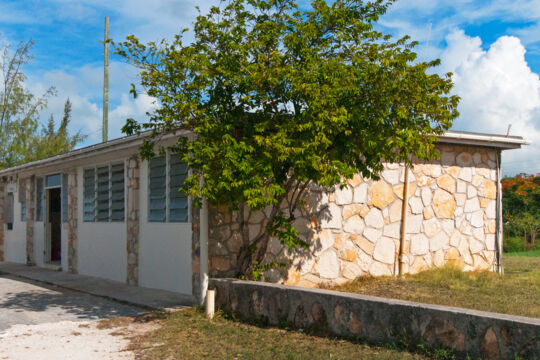 Exterior of a small stone airport on North Caicos