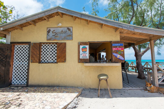 Entrance of a simple Grand Turk restaurant with a bar by the beach
