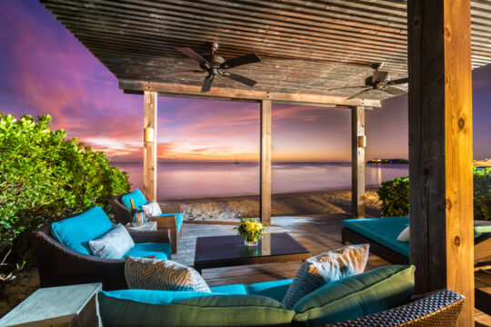 Beach cabana and loungers at dusk