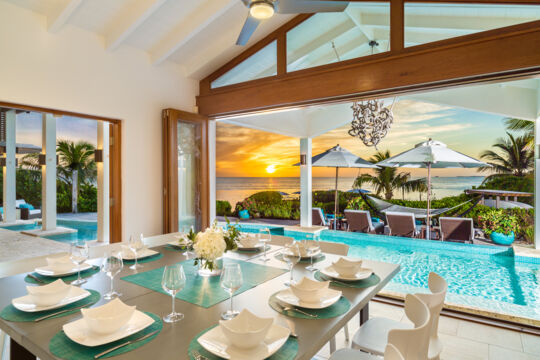 Dining table inside villa, at sunset