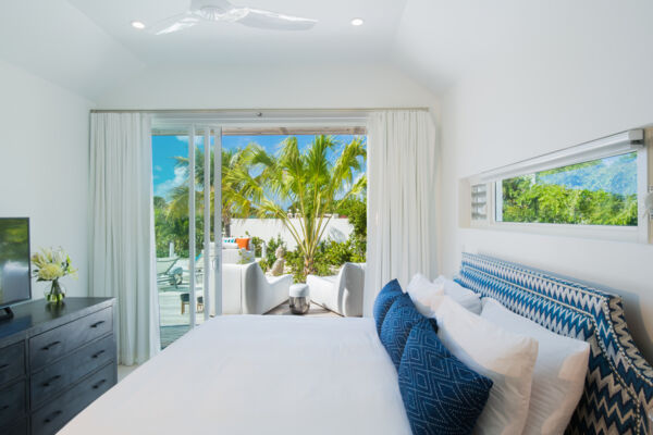 Bedroom with palm tree outside the window