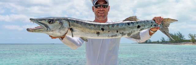 Fisherman holding up a barracuda in Turks and Caicos.