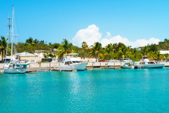 Boats docked in beautiful turquoise water at a marina
