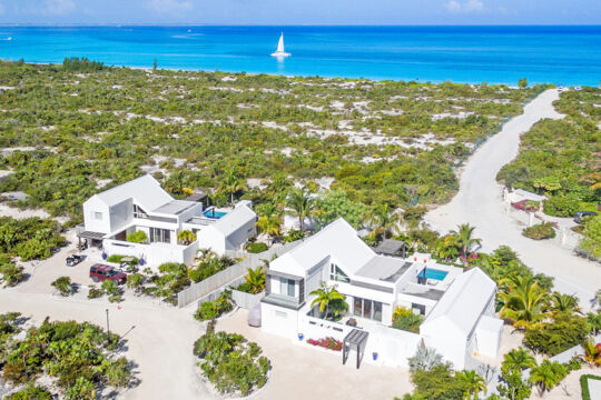 Modern white villas with beach path to the ocean