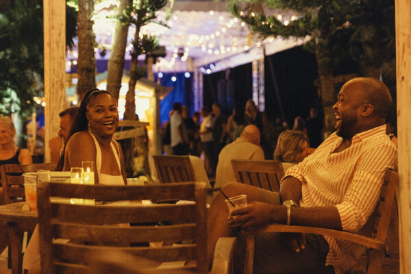 Couple laughing at an outdoor bar in Turks and Caicos.